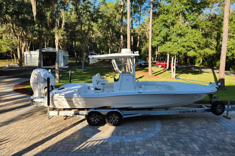 Slide: The Image of 2020 Caymas 28 HB boat on trailer in a wooded driveway setting. - 5