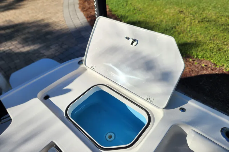 Slide: The Image of Open storage compartment on 2020 Caymas 28 HB boat, featuring a blue interior. - 51