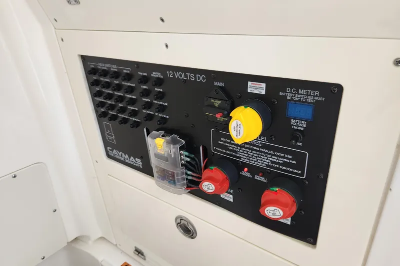 Slide: The Image of Control panel of 2020 Caymas 28 HB boat with switches and DC meter. - 54