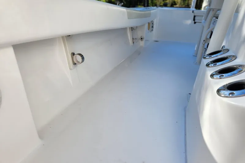 Slide: The Image of 2020 Caymas 28 HB boat interior with rod holders and sleek white deck. - 56