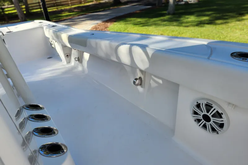 Slide: The Image of 2020 Caymas 28 HB boat interior with rod holders and speaker, showcasing sleek design. - 58