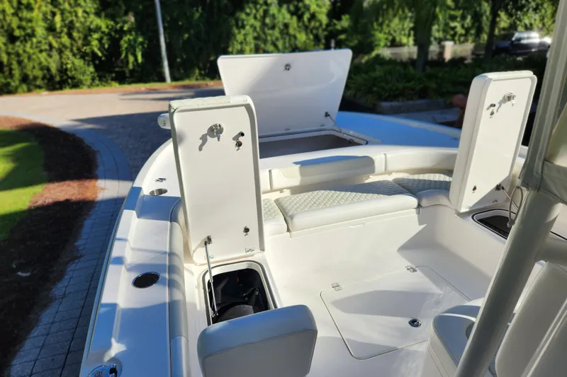 Slide: The Image of 2020 Caymas 28 HB boat interior with open storage compartments and seating. - 60