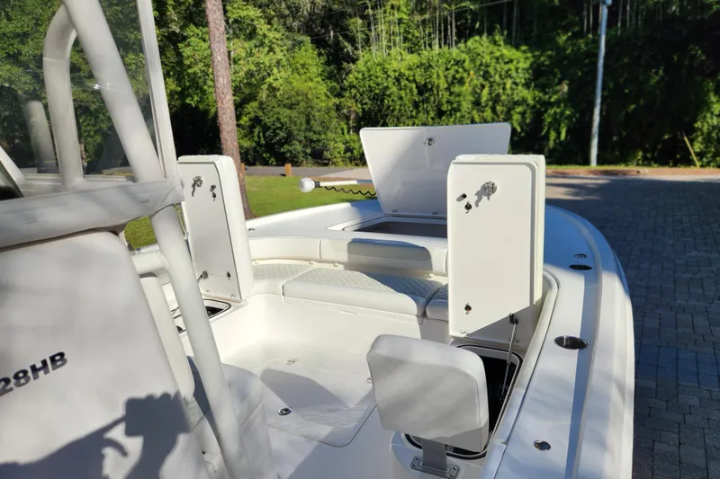 Slide: The Image of 2020 Caymas 28 HB boat interior with open storage compartments and seating. - 61