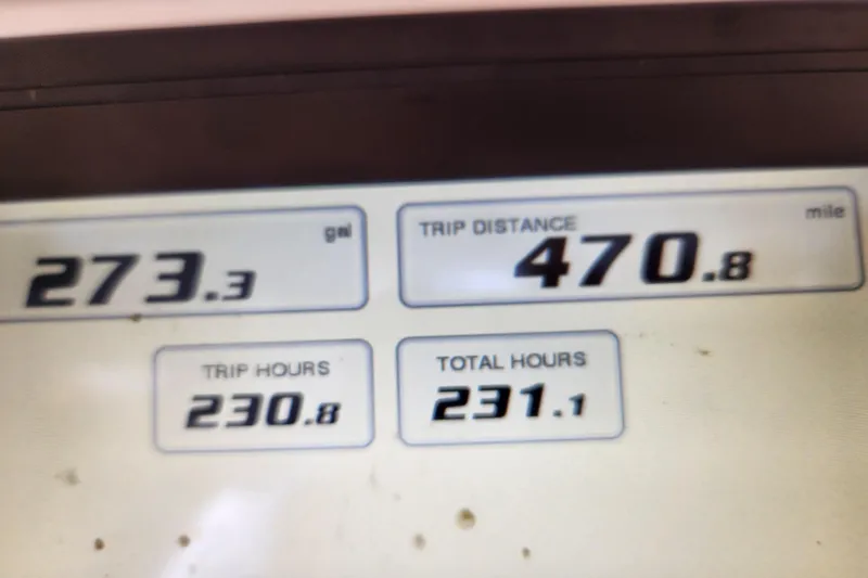Slide: The Image of Dashboard display showing fuel, trip distance, and hours for 2020 Caymas 28 HB boat. - 63