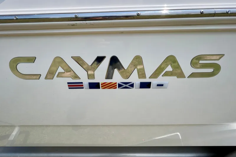 Slide: The Image of 2020 Caymas 28 HB boat logo with nautical flags on white background. - 64