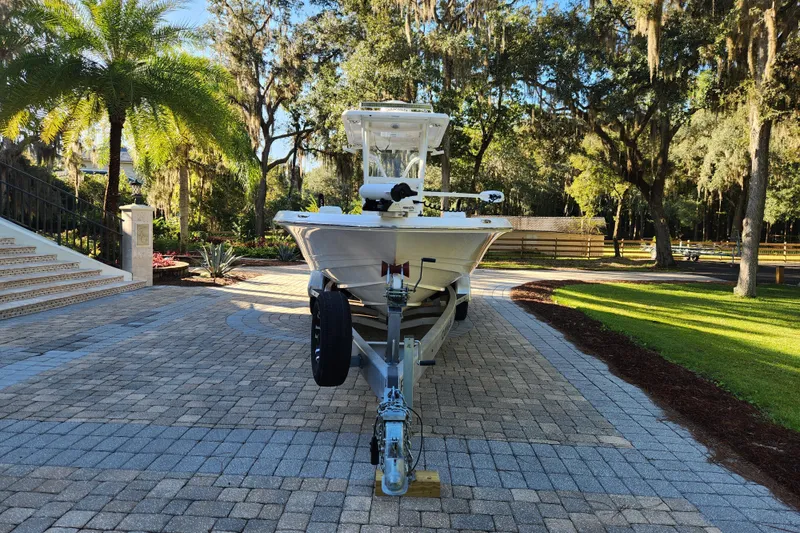Slide: The Image of 2020 Caymas 28 HB boat on trailer in scenic driveway setting. - 7