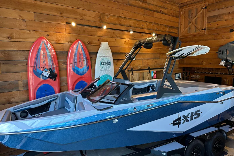 The Image of 2025 Axis T220 boat in wooden garage with surfboards displayed. - 0