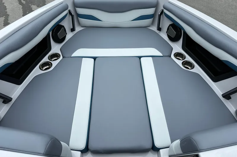 Slide: The Image of 2025 Axis T220 boat interior with gray and white cushioned seating and cup holders. - 10