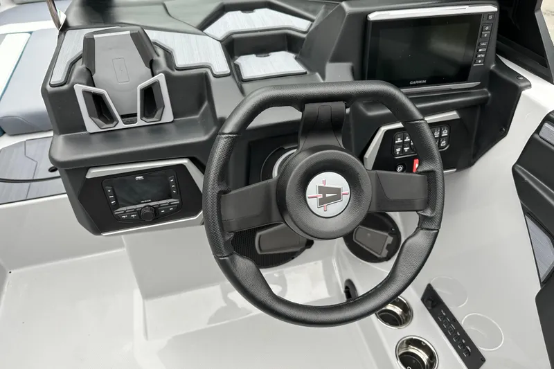 Slide: The Image of 2025 Axis T220 boat dashboard with steering wheel, digital displays, and control panel. - 11
