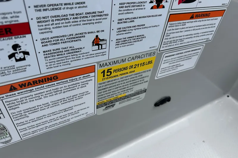 Slide: The Image of 2025 Axis T220 boat capacity warning label, maximum 15 persons or 2115 lbs. - 13