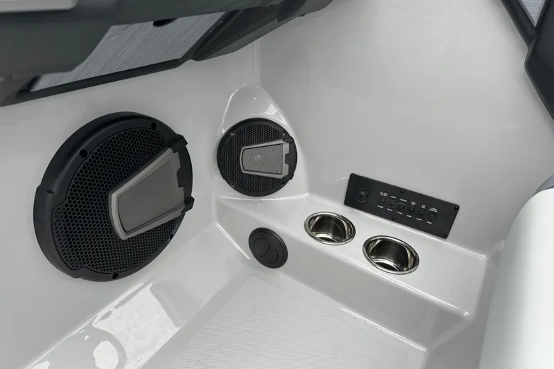 Slide: The Image of 2025 Axis T220 boat interior with speakers, control panel, and cup holders. - 5