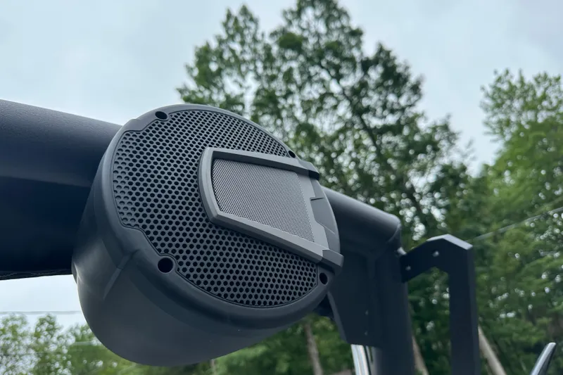Slide: The Image of Outdoor speaker on Axis T220 boat, 2025 model, with trees in the background. - 8