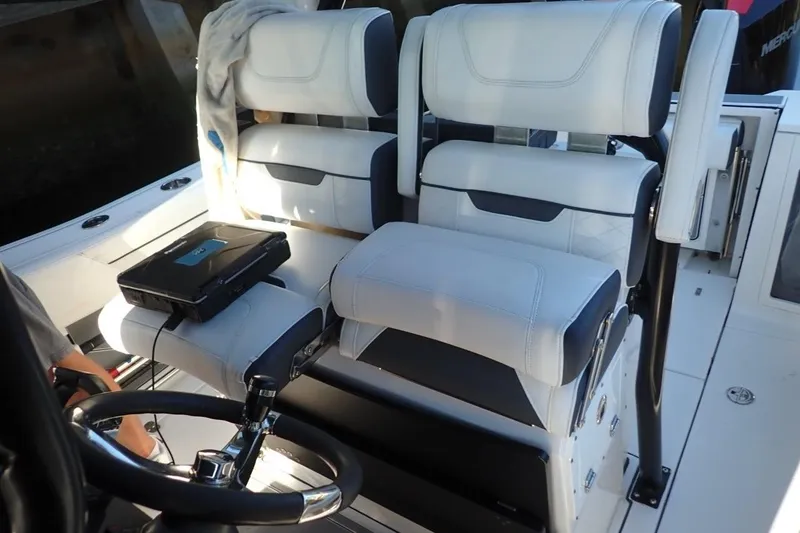 Slide: The Image of 2022 Blackfin 272 CC boat interior with seating and rod holders. - 12