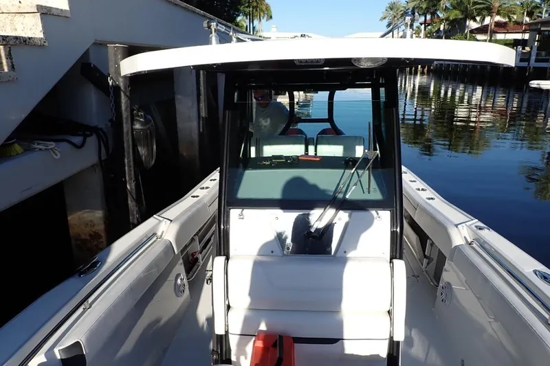 Slide: The Image of 2022 Blackfin 272 CC boat cockpit with steering wheel and control panel. - 18