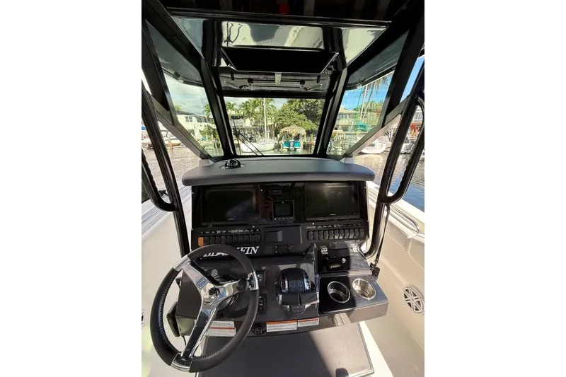 Slide: The Image of 2022 Blackfin 272 CC boat docked with dual outboard engines. - 19