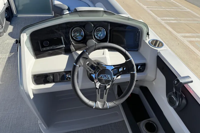 Slide: The Image of Steering console of 2026 Avalon LSZ Versatile Rear Bench boat with modern controls. - 24