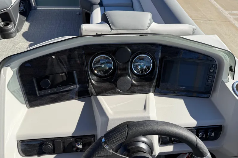 Slide: The Image of Dashboard of 2026 Avalon LSZ Versatile Rear Bench boat with modern controls and gauges. - 25