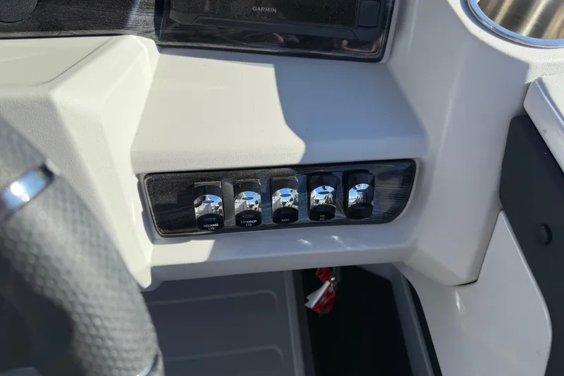 Slide: The Image of 2026 Avalon LSZ Versatile Rear Bench dashboard with control switches and Garmin display. - 27