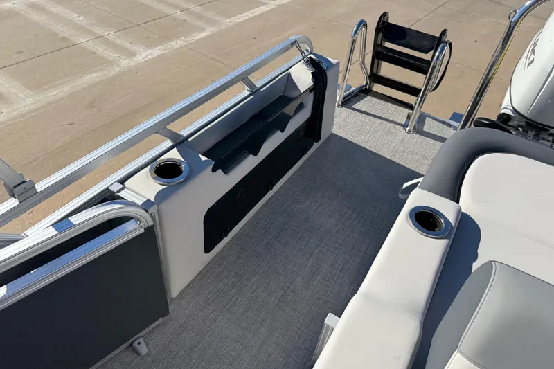 Slide: The Image of 2026 Avalon LSZ Versatile Rear Bench boat interior with cup holders and ladder. - 33