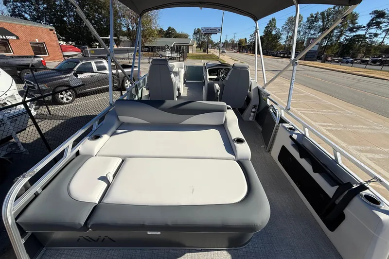 Slide: The Image of 2026 Avalon LSZ Versatile Rear Bench boat with spacious seating and canopy, parked outdoors. - 35