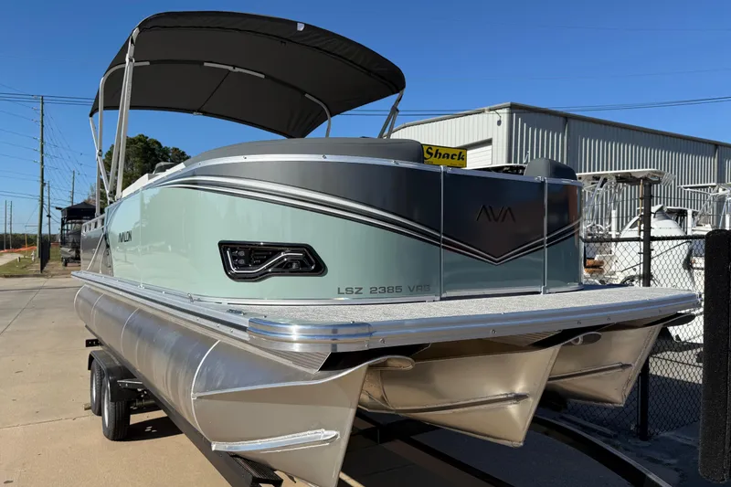 Slide: The Image of 2026 Avalon LSZ Versatile Rear Bench pontoon boat with sleek design and canopy. - 49