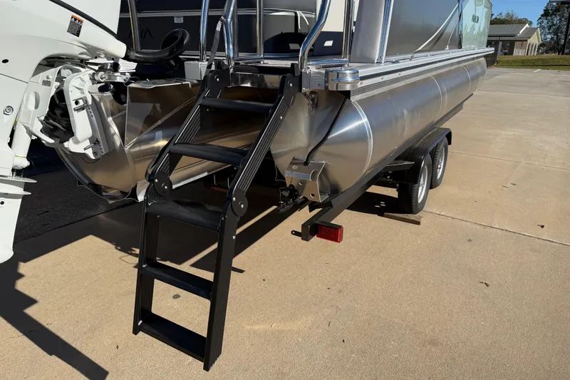 Slide: The Image of 2026 Avalon LSZ Versatile Rear Bench pontoon boat with ladder and trailer. - 7