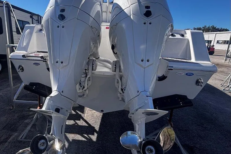Slide: The Image of 2026 Tidewater 302 CC Adventure boat with dual outboard engines, rear view. - 13