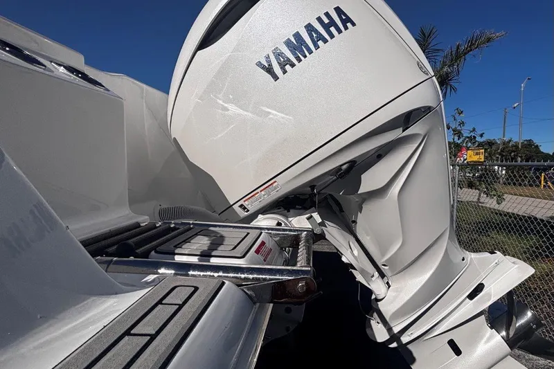 Slide: The Image of 2026 Tidewater 302 CC Adventure with Yamaha outboard motor, docked under clear blue sky. - 15