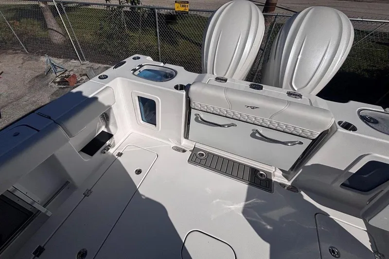 Slide: The Image of 2026 Tidewater 302 CC Adventure boat interior with seating and storage compartments. - 23