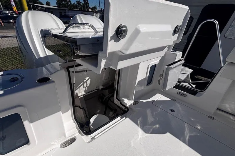 Slide: The Image of 2026 Tidewater 302 CC Adventure boat with open storage compartment and sleek design. - 24