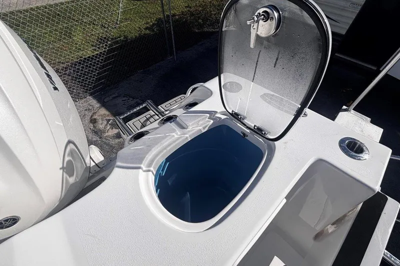 Slide: The Image of 2026 Tidewater 302 CC Adventure boat with open livewell and engine detail. - 26