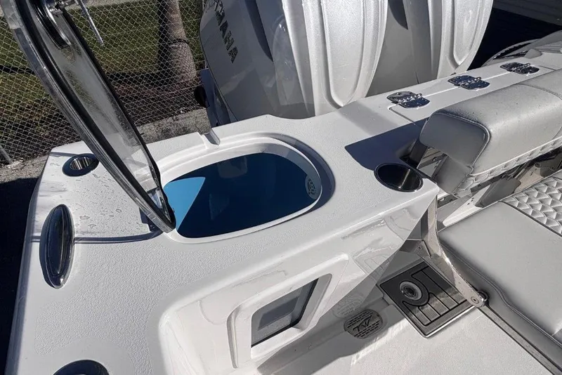 Slide: The Image of 2026 Tidewater 302 CC Adventure boat interior with open compartment and seating. - 27