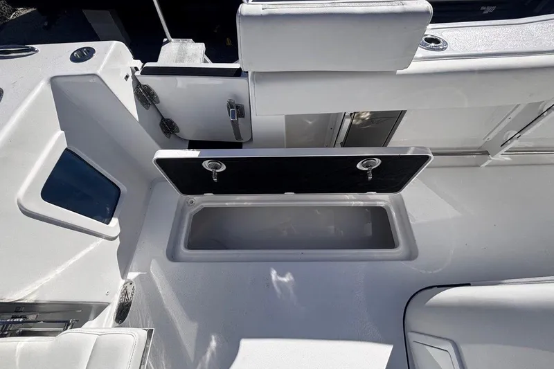 Slide: The Image of 2026 Tidewater 302 CC Adventure boat interior with open storage compartment. - 29