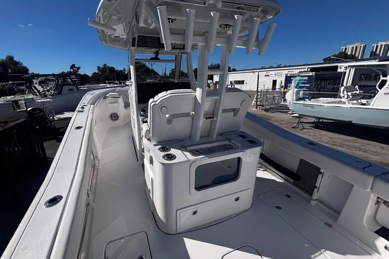 Slide: The Image of 2026 Tidewater 302 CC Adventure boat interior with seating and storage, docked outdoors. - 31