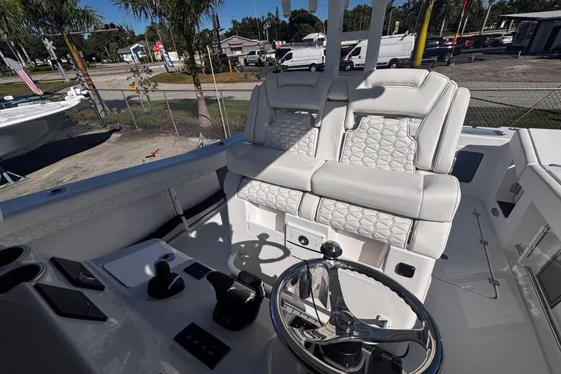 Slide: The Image of 2026 Tidewater 302 CC Adventure boat cockpit with luxurious seating and modern controls. - 36