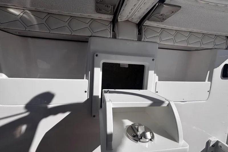 Slide: The Image of Interior view of 2026 Tidewater 302 CC Adventure boat, featuring storage compartments. - 38