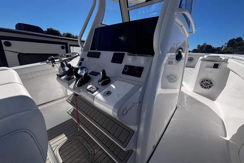 Slide: The Image of 2026 Tidewater 302 CC Adventure boat cockpit with modern controls and seating. - 39