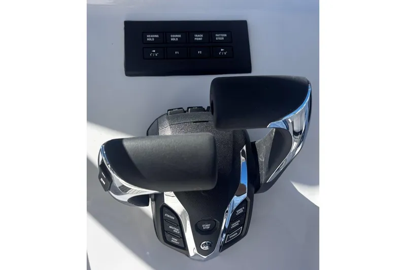 Slide: The Image of Throttle controls of a 2026 Tidewater 302 CC Adventure boat, featuring advanced navigation buttons. - 42