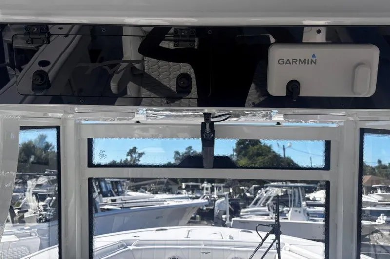 Slide: The Image of 2026 Tidewater 302 CC Adventure boat with Garmin navigation system, docked in marina. - 46