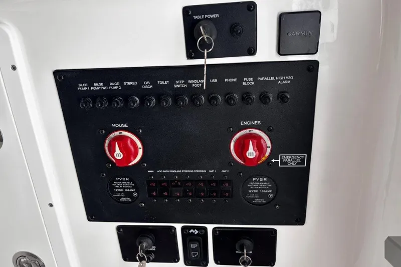 Slide: The Image of Control panel of 2026 Tidewater 302 CC Adventure boat with switches and dials. - 53