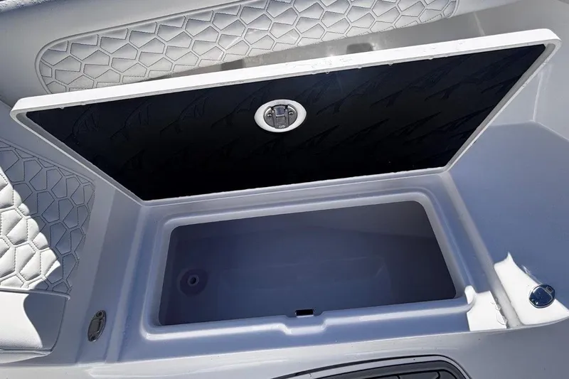 Slide: The Image of Open storage compartment on 2026 Tidewater 302 CC Adventure boat with cushioned seating. - 59