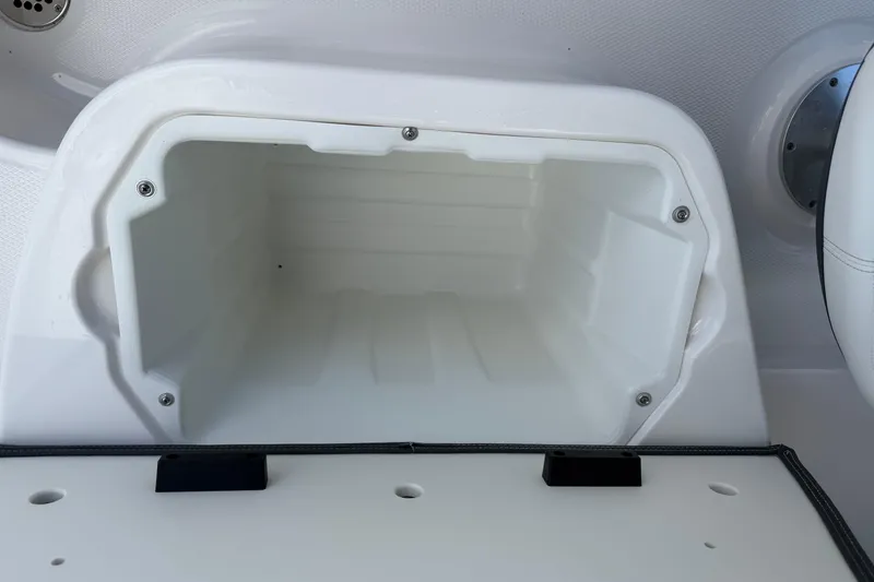 Slide: The Image of Storage compartment in 2024 Chaparral 270 OSX boat, featuring a sleek white interior design. - 12