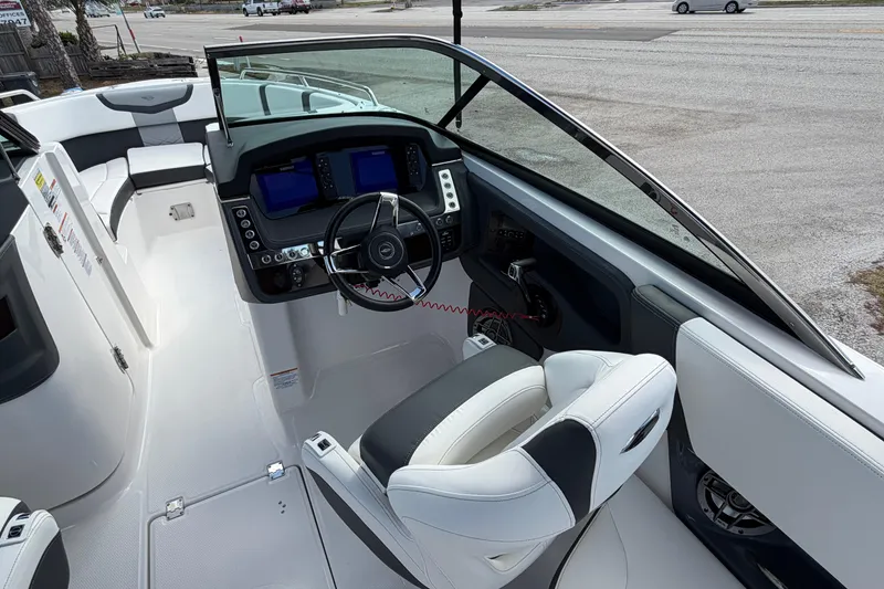 Slide: The Image of 2024 Chaparral 270 OSX boat cockpit with modern controls and seating. - 3