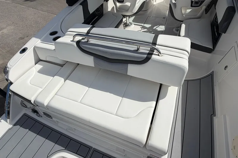 Slide: The Image of 2024 Chaparral 270 OSX boat interior with luxurious white seating and modern design. - 7