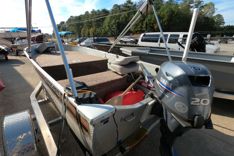 Slide: The Image of 1994 MIRRO CRAFT 15 boat with Yamaha 20 outboard motor, parked on a trailer. - 2