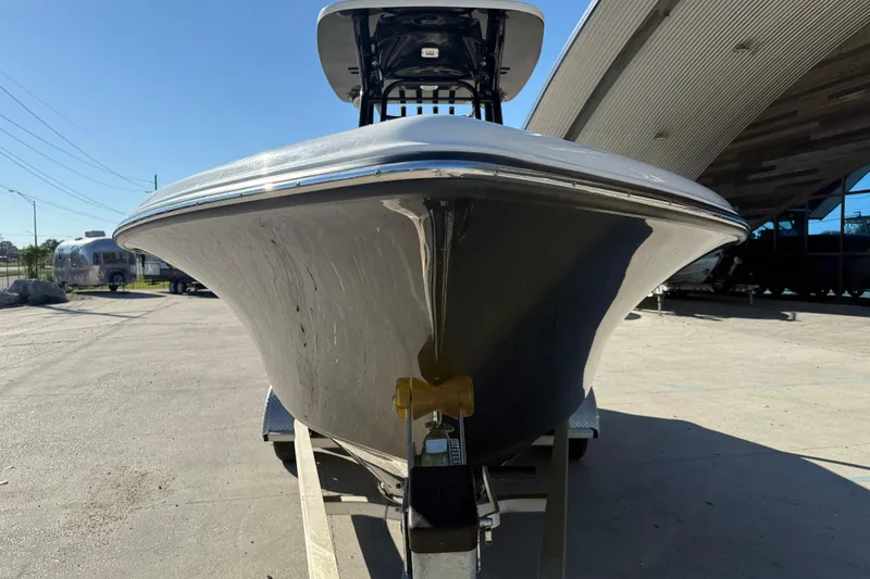 Slide: The Image of 2022 Key West 239 FS boat on trailer, parked outdoors under clear sky. - 3