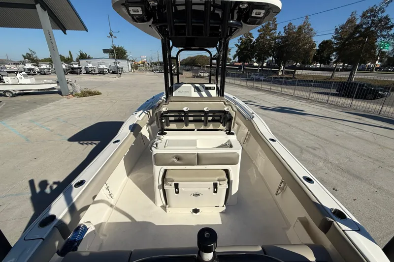 Slide: The Image of 2022 Key West 239 FS boat interior with console and seating, parked outdoors. - 8