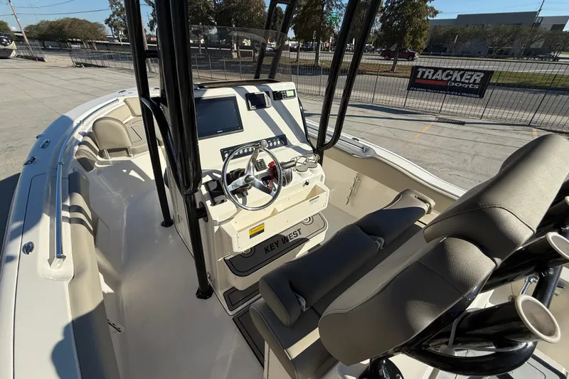 Slide: The Image of 2022 Key West 239 FS boat interior with steering console and seating. - 9