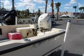 Slide: The Image of 1994 Key West 1720 Sportsman boat docked, side view with registration number visible. - 3