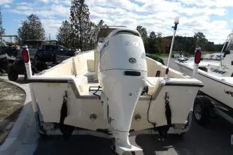 Slide: The Image of 1994 Key West 1720 Sportsman boat with Suzuki outboard motor in a parking lot. - 4